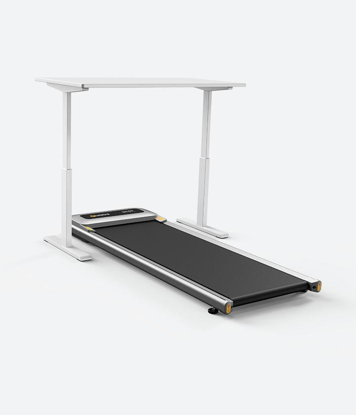 Man seamlessly combines work and fitness with Urevo Under Desk Treadmill - Stay active, stay productive.