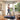 A woman uses a walking pad with a handrail for secure grip and enhanced stability during her indoor workout session.