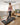 UREVO SpaceWalk E4 walking pad with real-time data display: speed, distance, time, and calories. Woman exercising at home