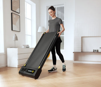 Enjoy light exercise at home! A woman handles the slim UREVO SpaceWalk 3S Smart Walking Pad in her bright living room