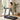 Woman walking on a compact treadmill in a bright home workout space