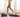A woman running on a treadmill set at a 9% incline in a room.