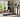 Woman lightly jogging on a walking pad in a modern home office.