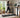 Woman lightly jogging on a walking pad in a modern home office.