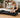 Woman lubricating a compact treadmill belt in a living room.