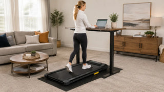 White woman working while walking on a treadmill in a carpeted living room.