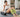 Woman wearing green leg massagers beside a foam roller after a workout