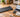 UREVO walking pad beside a laptop, calculator, and budget notebook