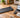 UREVO walking pad beside a laptop, calculator, and budget notebook