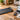 UREVO walking pad beside a laptop, calculator, and budget notebook