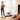 A woman watches her dog use the UREVO SpaceWalk E1 Walking Pad as her son plays in the living room