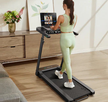 A person is using a treadmill in a living room