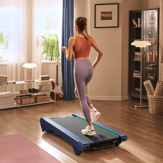 A woman in workout gear runs on a treadmill in a cozy, well-lit living room with wooden floors and modern decor.