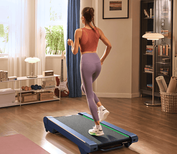 A woman in workout gear runs on a treadmill in a cozy, well-lit living room with wooden floors and modern decor.