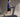  A man in a blue shirt and black shorts is walking on a treadmill.