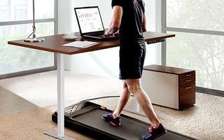 Man walking with a UREVO under-desk treadmill