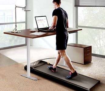 Man walking with a UREVO under-desk treadmill