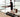 A man works productively at his standing desk, staying active using the sleek UREVO SpaceWalk E1L Smart Walking Pad at home