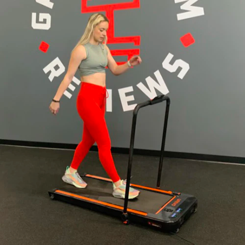 A fit lady walking on a Urevo walking pad
