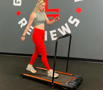 A fit lady walking on a Urevo walking pad