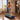 A woman in workout gear runs on a treadmill in a cozy living room with a guitar, bookshelf, and large window.