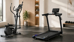 Elliptical trainer beside a UREVO treadmill in a sunlit fitness room.