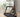 A woman demonstrates easy storage for a compact treadmill.