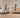 Two women are exercising on treadmills in a modern, minimalist room with wooden floors