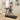 Woman walking on a treadmill while using a laptop in a home setting.