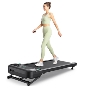 Woman walking on SpaceWalk 5L Smart Walking Pad, a compact fitness device for home workouts.